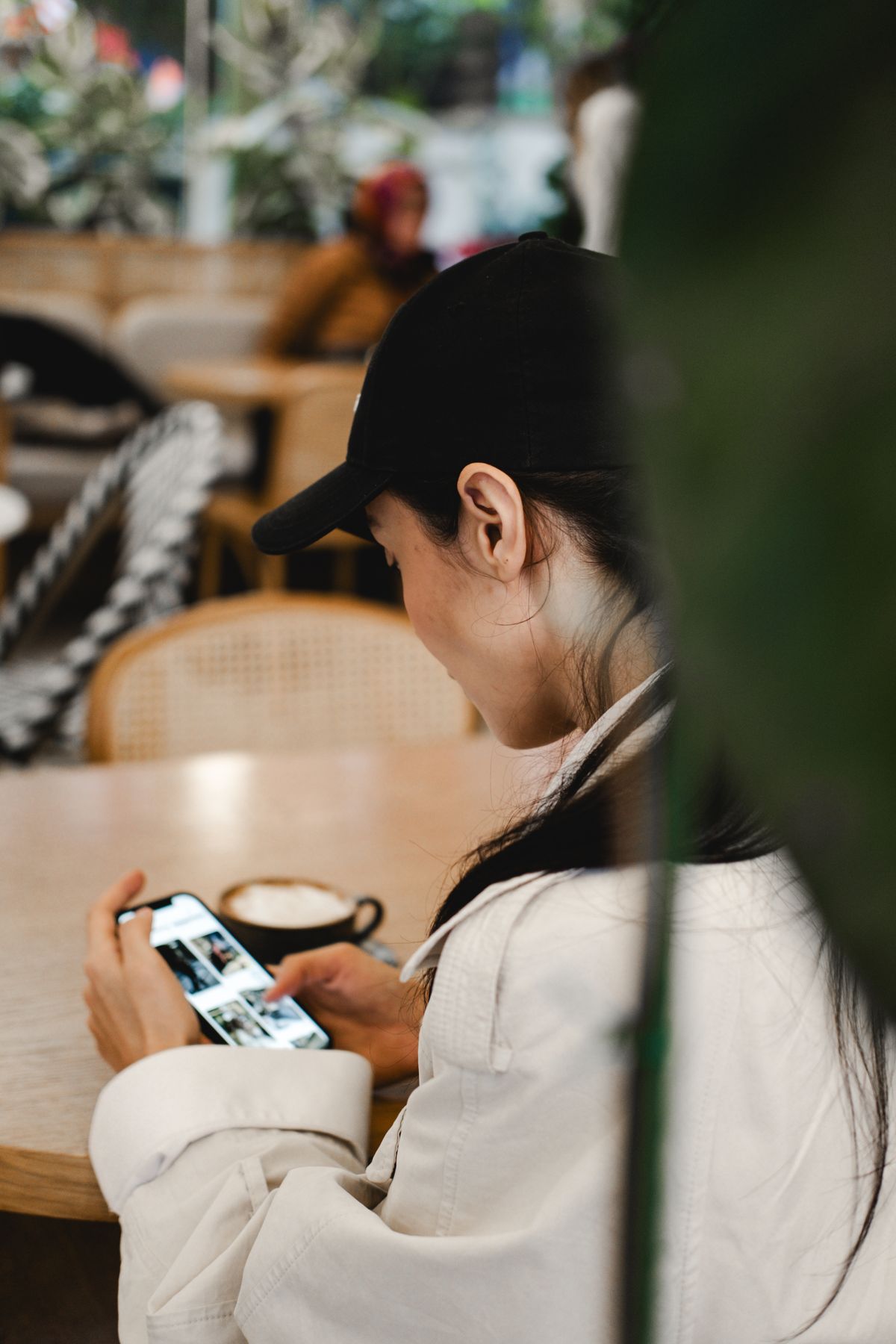Business owner reviewing email marketing traffic results on phone